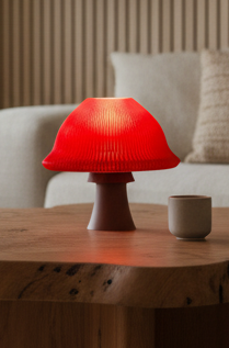 Amanita mushroom table lamp with a sculptural design casting a soft ambient glow.
