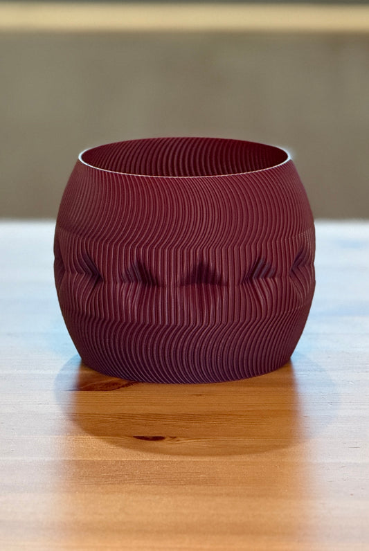 Contemporary Firkle planter featuring smooth curves and a bold 3D-printed form.