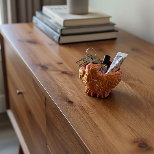 Parrot Bowl displayed on a wooden credenza holding keys and coins, adding tropical character to modern home décor.