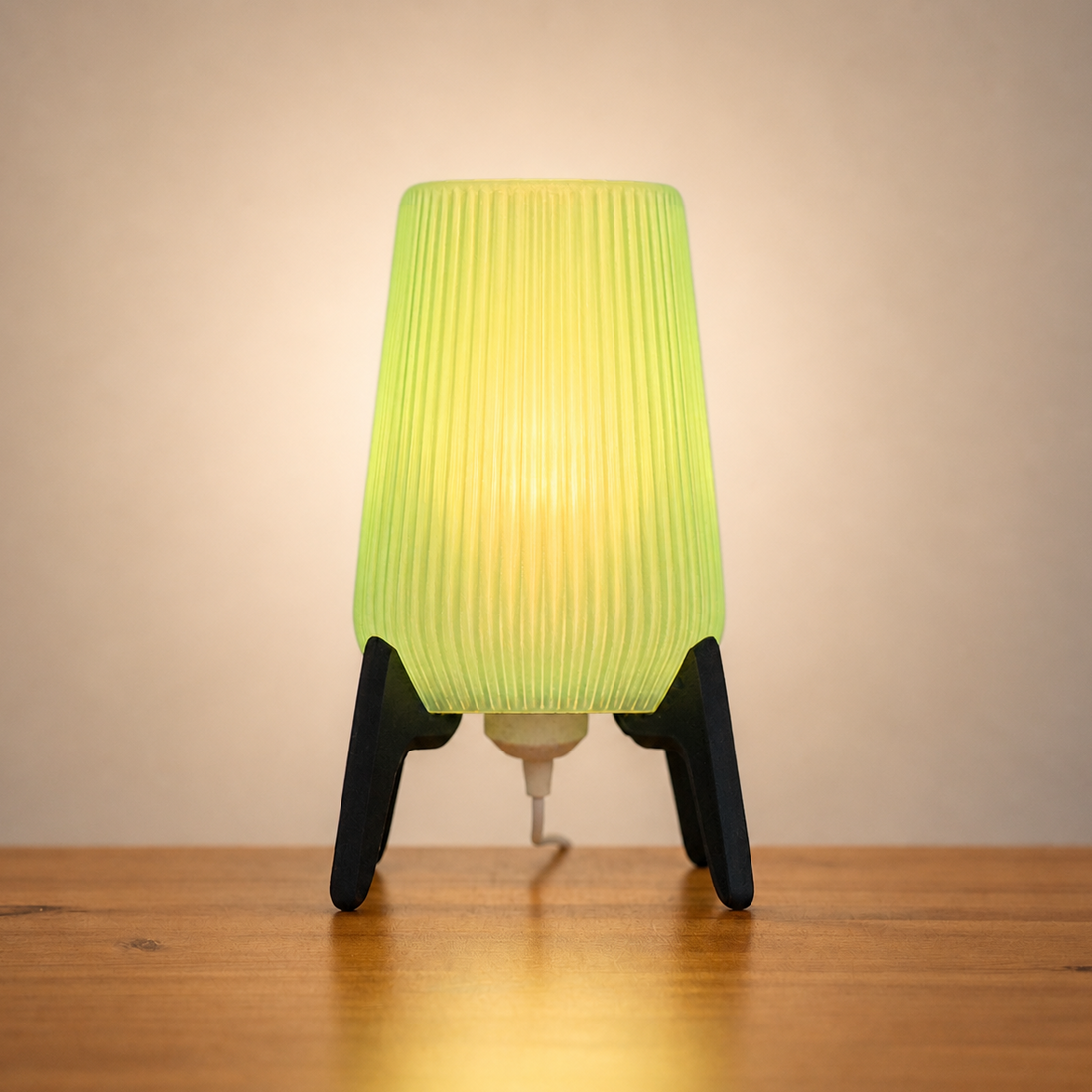 Freya Table Lamp with tapered grooved shade, soft green glow, and angled legs