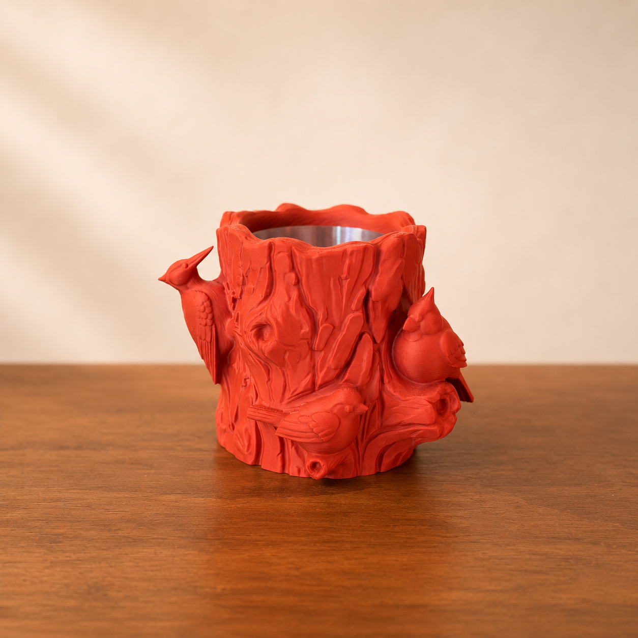 Decorative log planter featuring realistic bark textures and sculpted birds, designed for small indoor plants.