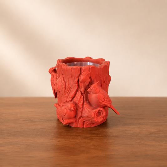 Feathered Forest Log Planter with detailed tree bark texture and perched bird accents, shown as a decorative woodland planter.