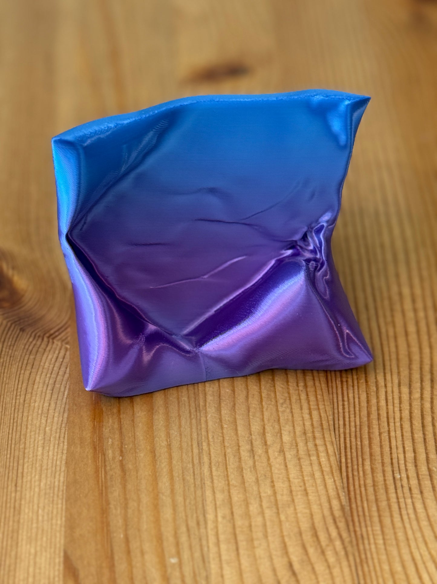 The Card Cradle sculptural desk accessory holding cards upright