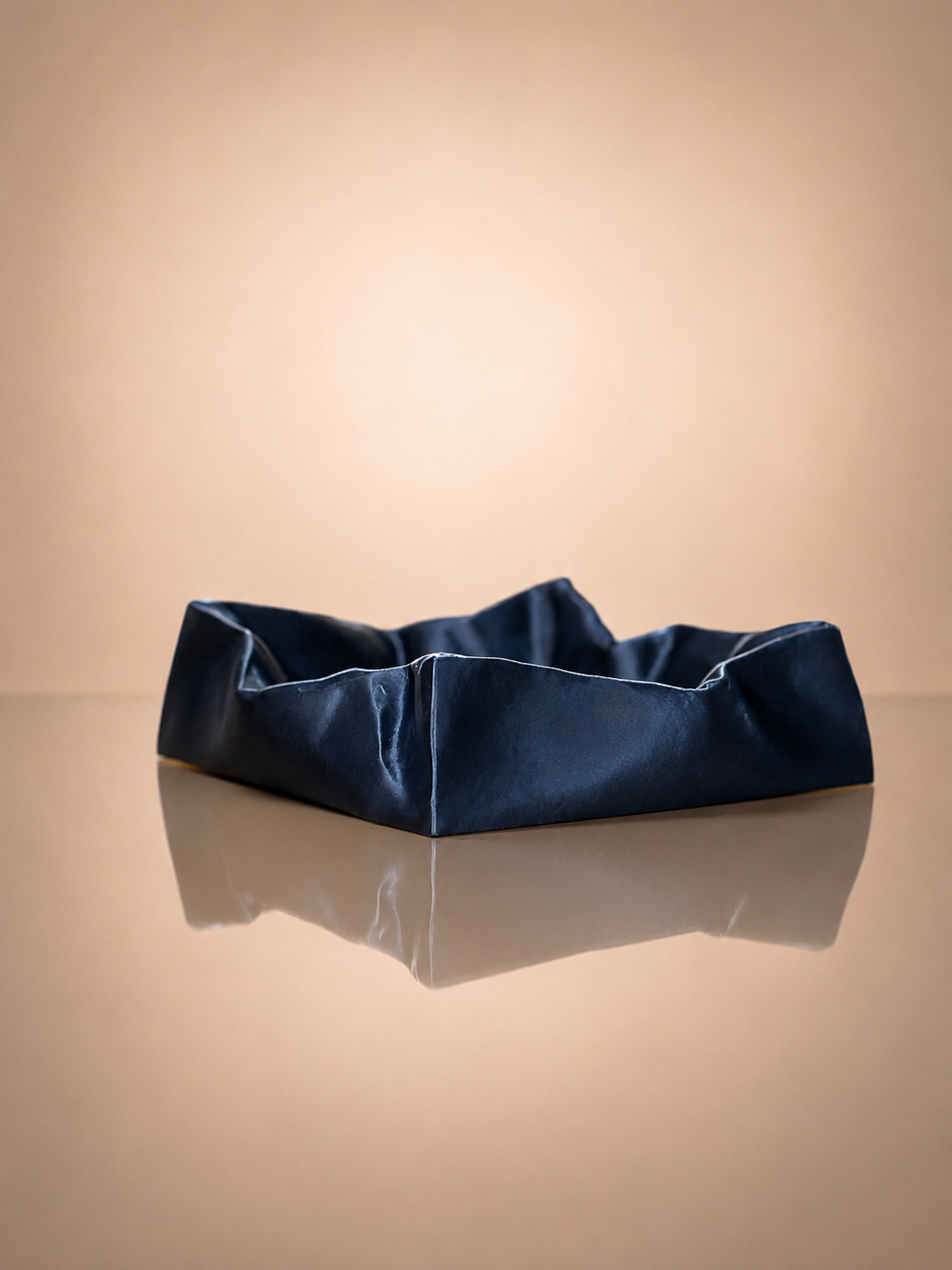 Contemporary catchall tray with a sculptural cushioned design, ideal for organizing keys, jewelry, and small items.