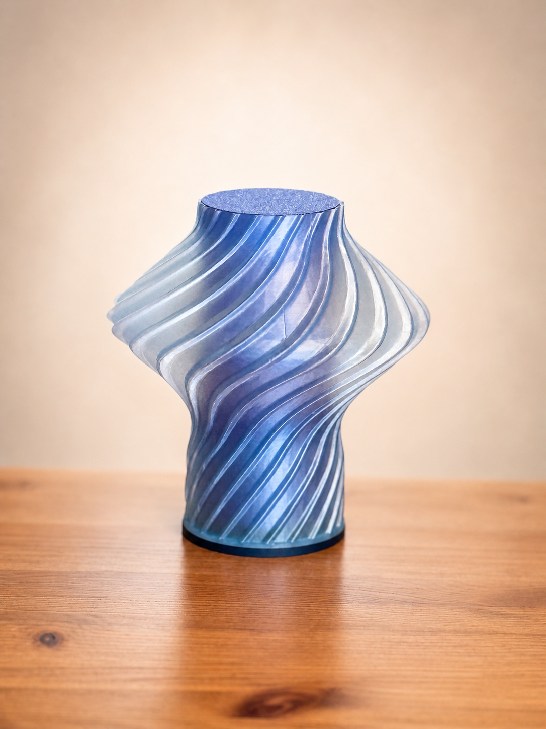 Side view of the Carla Table Lamp showcasing its flowing sculptural form and textured 3D printed design.