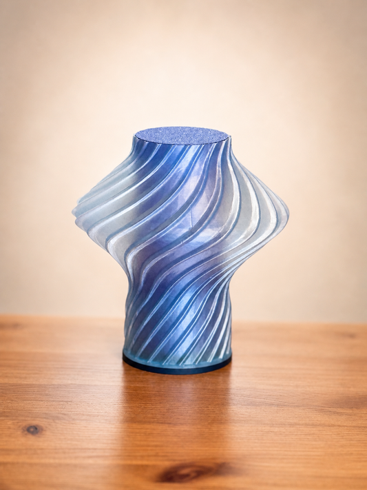 Side view of the Carla Table Lamp showcasing its flowing sculptural form and textured 3D printed design.