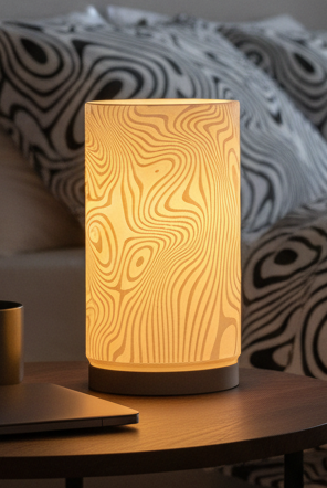 Drift Glow lamp with a modern sculptural design casting a soft ambient glow.