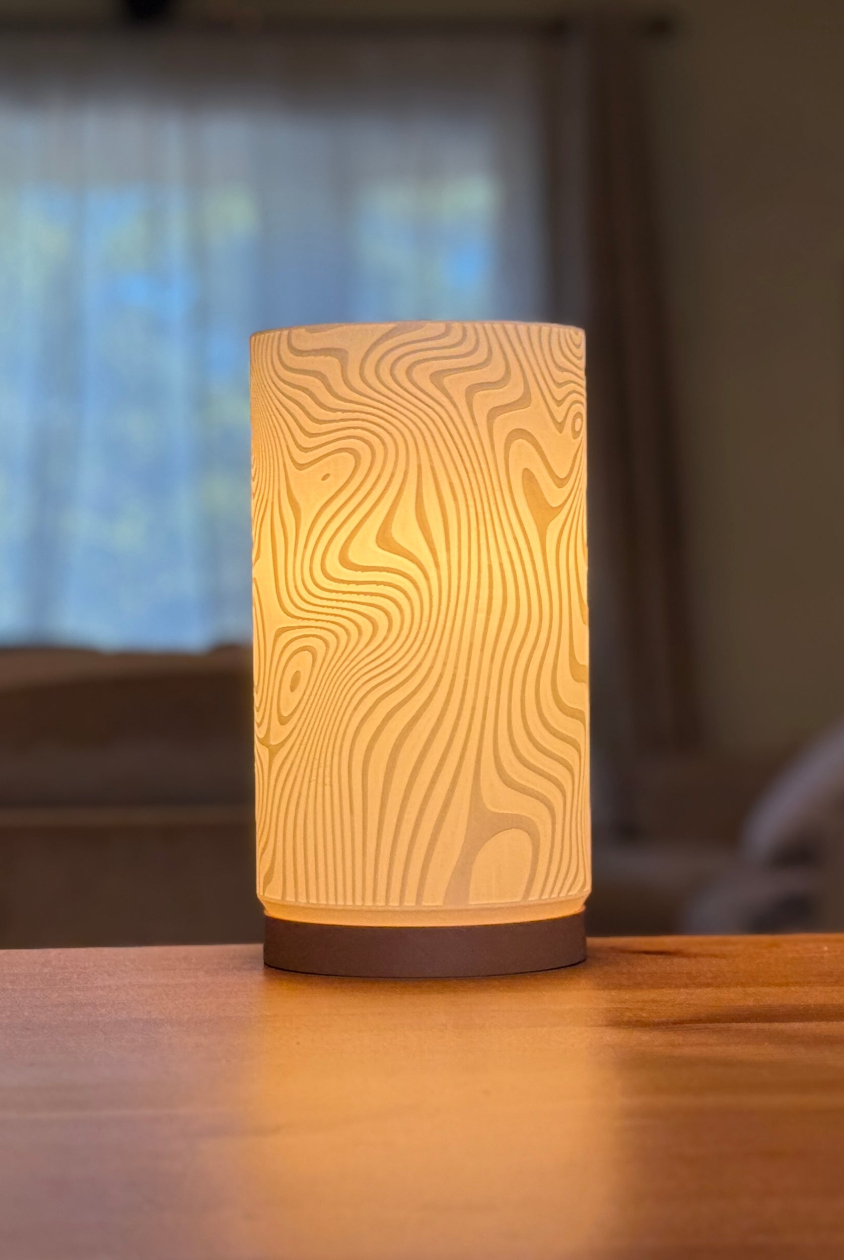 Contemporary Drift Glow lamp used as ambient lighting in a minimalist interior.