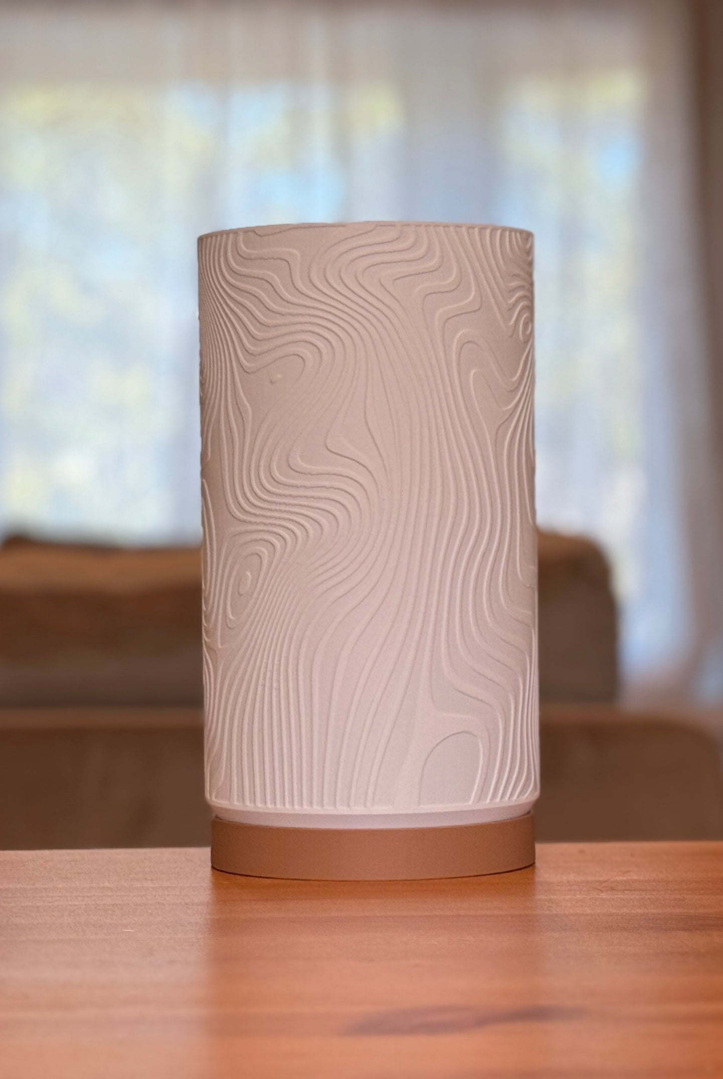 Modern Drift Glow table lamp featuring a smooth organic form and warm diffused lighting.