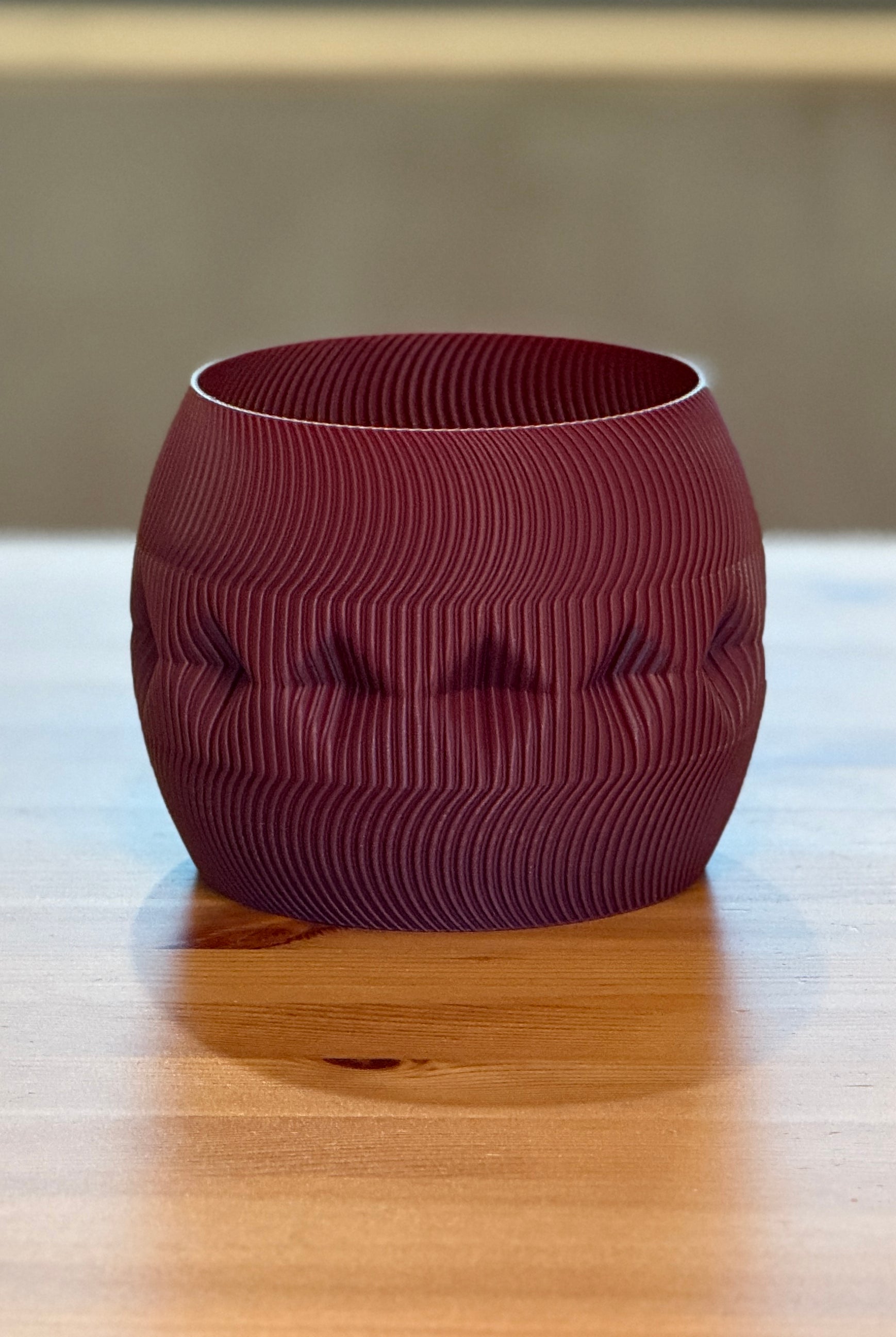 Contemporary Firkle planter featuring smooth curves and a bold 3D-printed form.