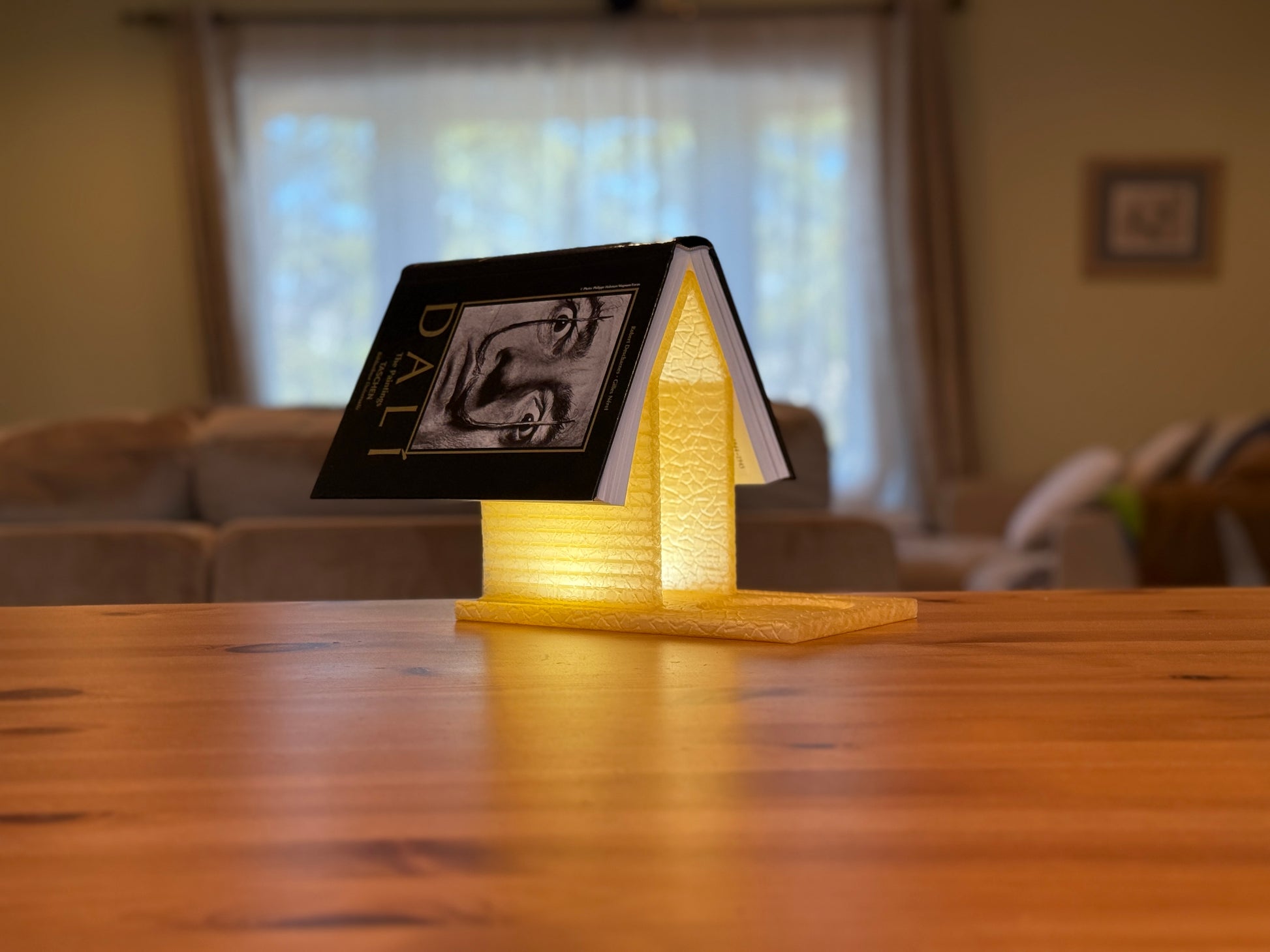 Artistic House of Books Lamp featuring layered book details and ambient lighting