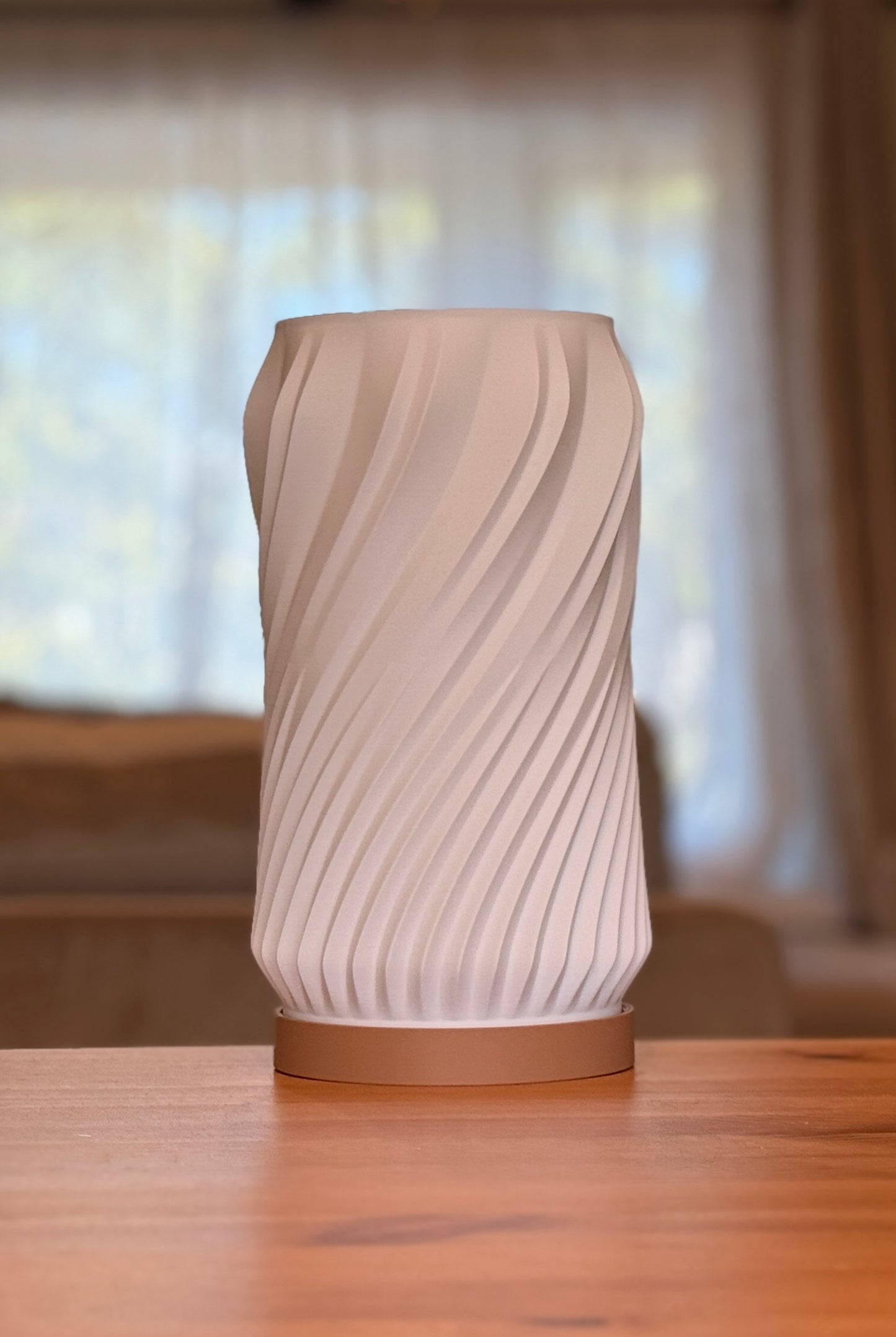 Modern minimalist spiral table lamp featuring a smooth flowing form.