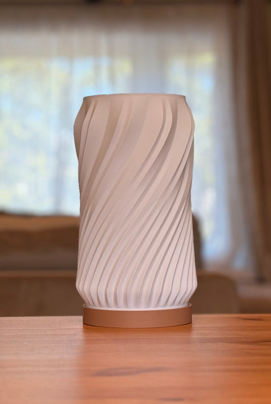 Modern minimalist spiral table lamp featuring a smooth flowing form.