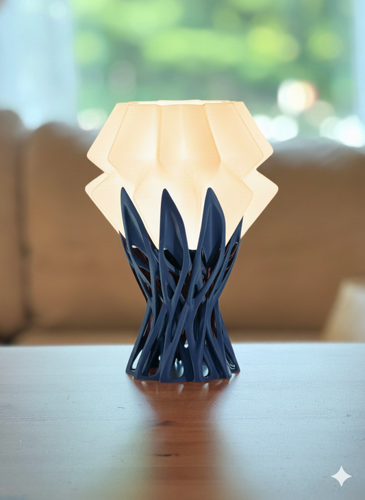Nox table lamp with sculptural base and warm glowing shade on wooden table