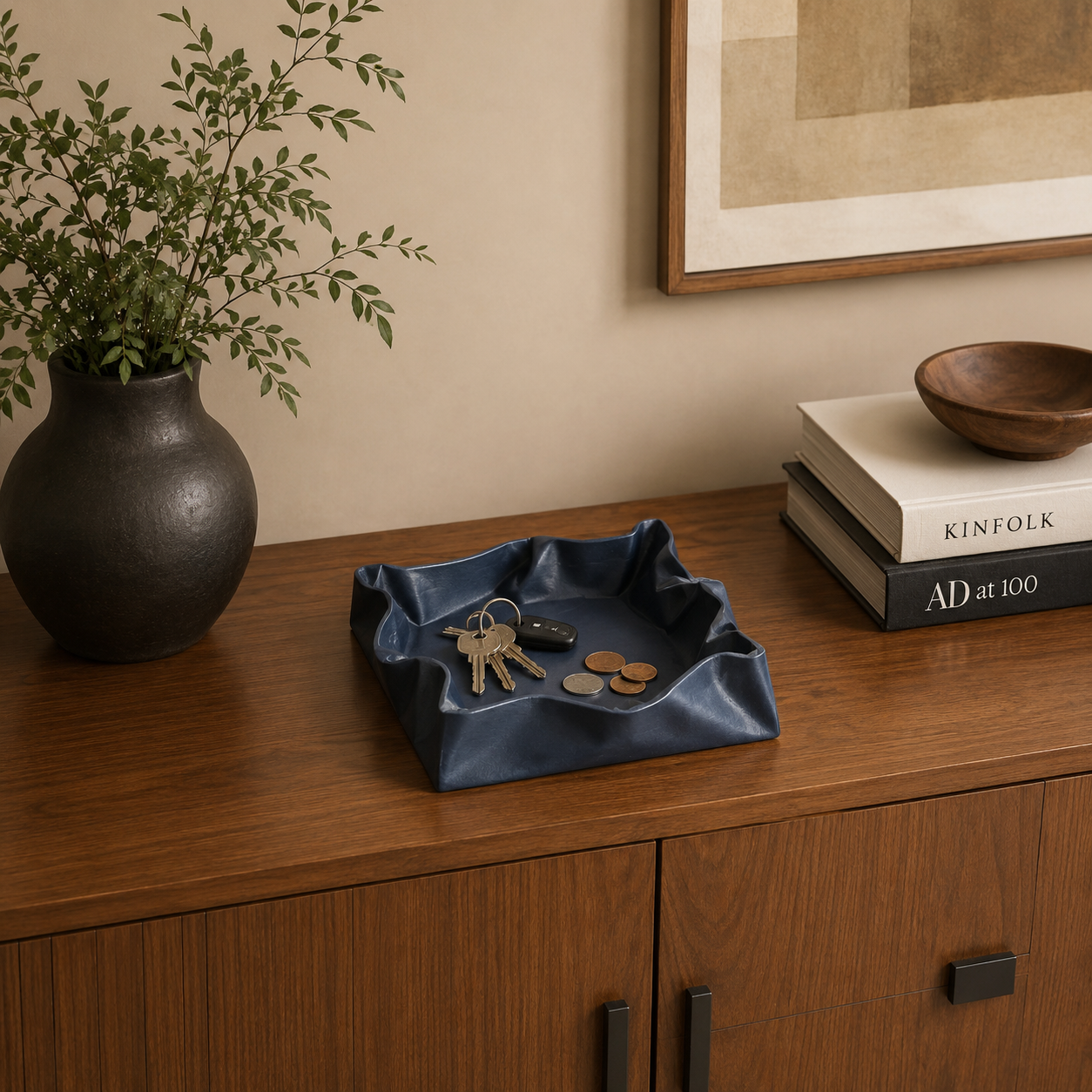 Puffy Valet Organizer displayed on a wooden credenza with everyday essentials, adding modern style and organization.